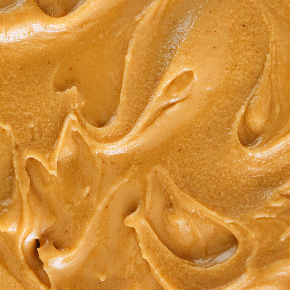 Textura cremosa en close-up de la crema de maní WAKEUP natural 100%, sin azúcar añadida